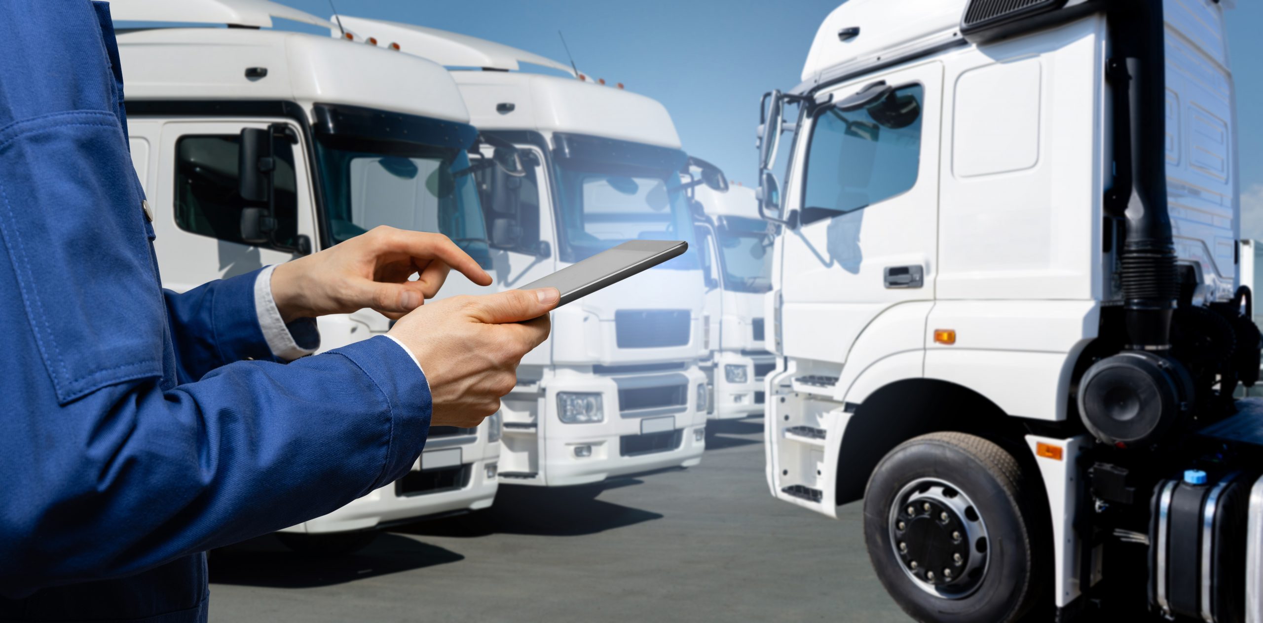 a man in blue uniform oversees multiple white trucks with transit insurance